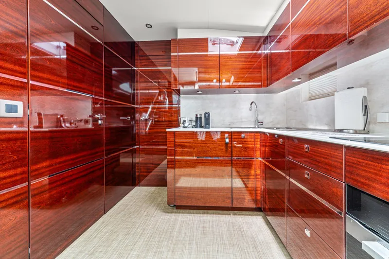 Slide: The Image of Luxurious kitchen interior on 2021 Steeler 60S Performance yacht with glossy wood cabinets. - 39