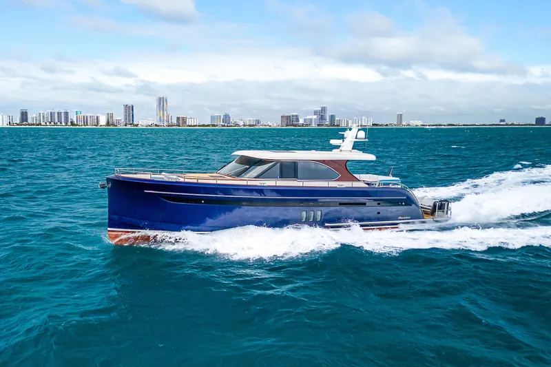 Slide: The Image of 2021 Steeler 60S Performance yacht cruising on blue ocean near city skyline. - 6