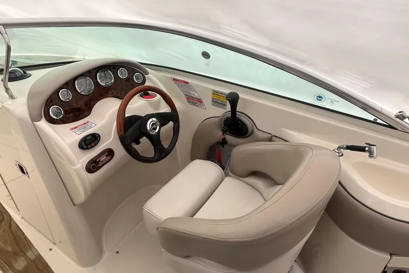 Slide: The Image of 2004 Sea Ray 220 Sundeck boat interior with steering wheel and control panel. - 10