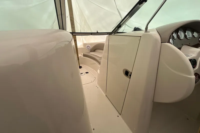 Slide: The Image of 2004 Sea Ray 220 Sundeck interior with dashboard and seating area. - 17