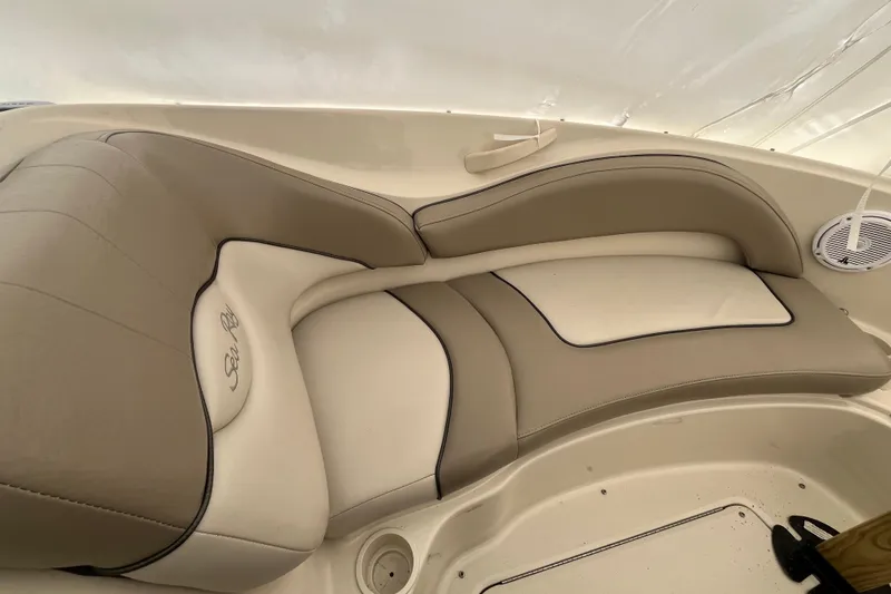 Slide: The Image of 2004 Sea Ray 220 Sundeck interior seating with beige and white upholstery. - 22