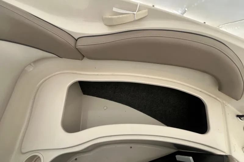 Slide: The Image of 2004 Sea Ray 220 Sundeck interior storage compartment with cushioned seating. - 23