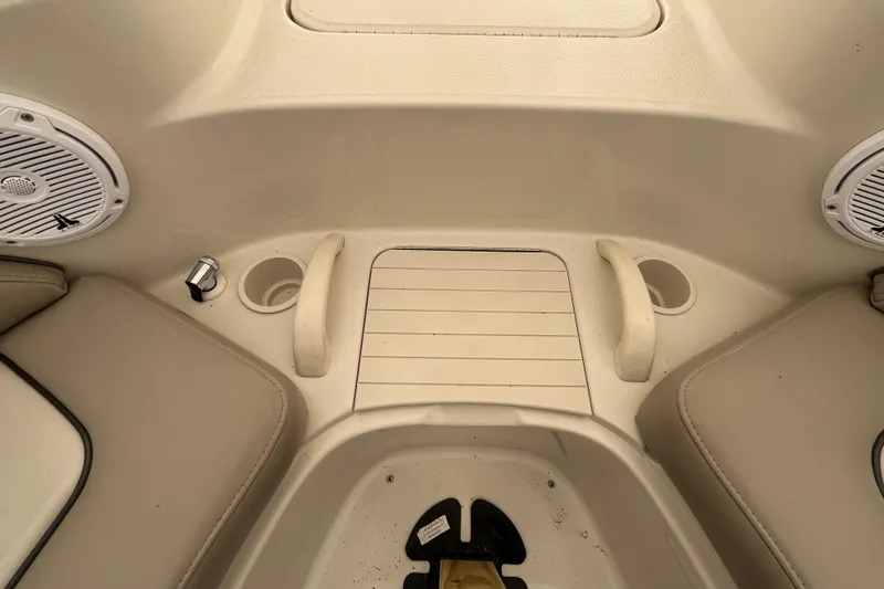 Slide: The Image of 2004 Sea Ray 220 Sundeck interior with cup holders and speakers. - 26