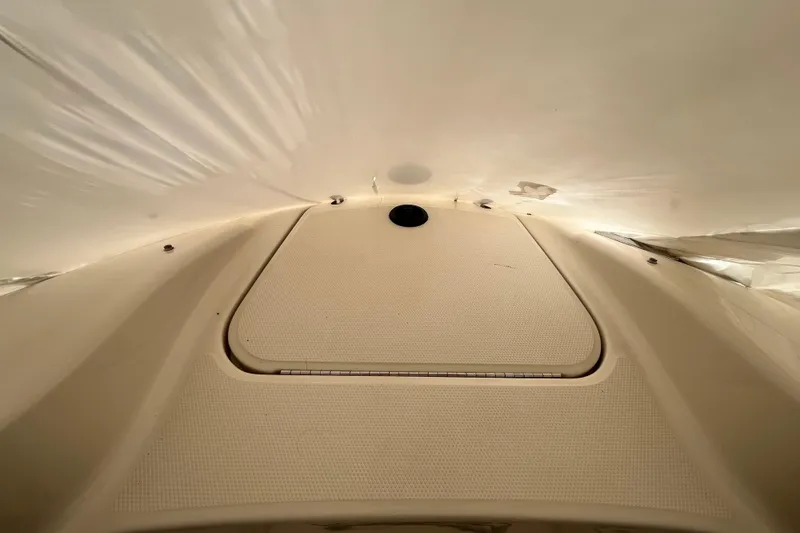 Slide: The Image of 2004 Sea Ray 220 Sundeck boat interior, featuring a textured deck surface. - 28