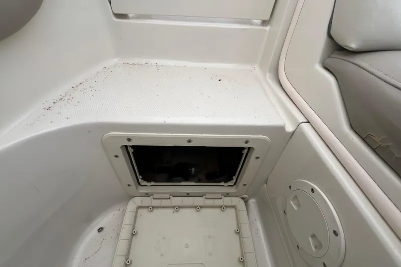 Slide: The Image of 2004 Sea Ray 220 Sundeck interior storage compartment with open hatch. - 31
