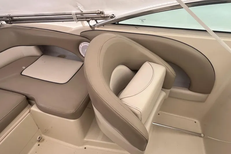 Slide: The Image of Interior of 2004 Sea Ray 220 Sundeck boat with beige seating and speaker. - 7