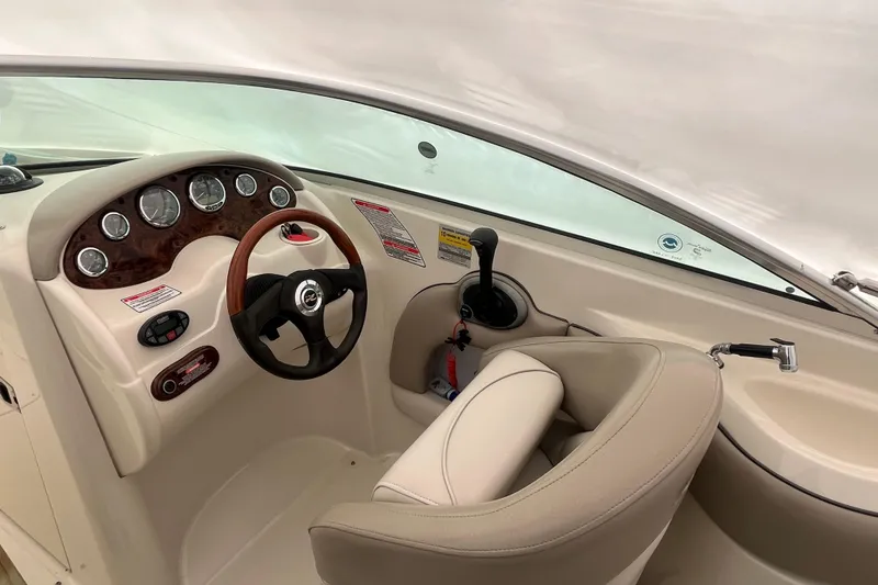 Slide: The Image of 2004 Sea Ray 220 Sundeck boat interior with steering wheel and dashboard controls. - 9