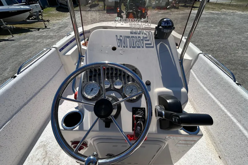 Slide: The Image of 2020 Carolina Skiff 178 DLV boat dashboard with steering wheel and controls. - 13