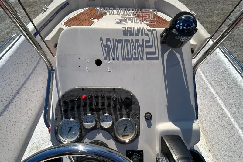 Slide: The Image of 2020 Carolina Skiff 178 DLV boat dashboard with gauges and compass. - 14