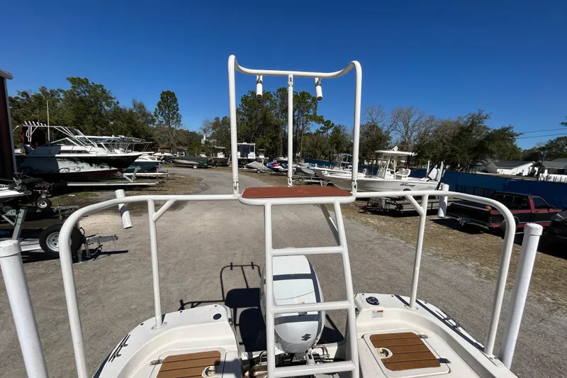 Slide: The Image of 2020 Carolina Skiff 178 DLV boat with elevated platform, parked outdoors. - 15