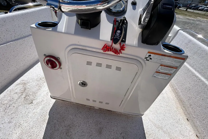 Slide: The Image of 2020 Carolina Skiff 178 DLV console with controls and safety warnings. - 19