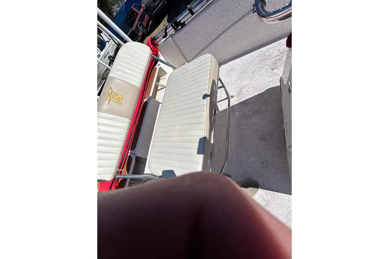 Slide: The Image of 2020 Carolina Skiff 178 DLV boat interior with white cushioned seating. - 20