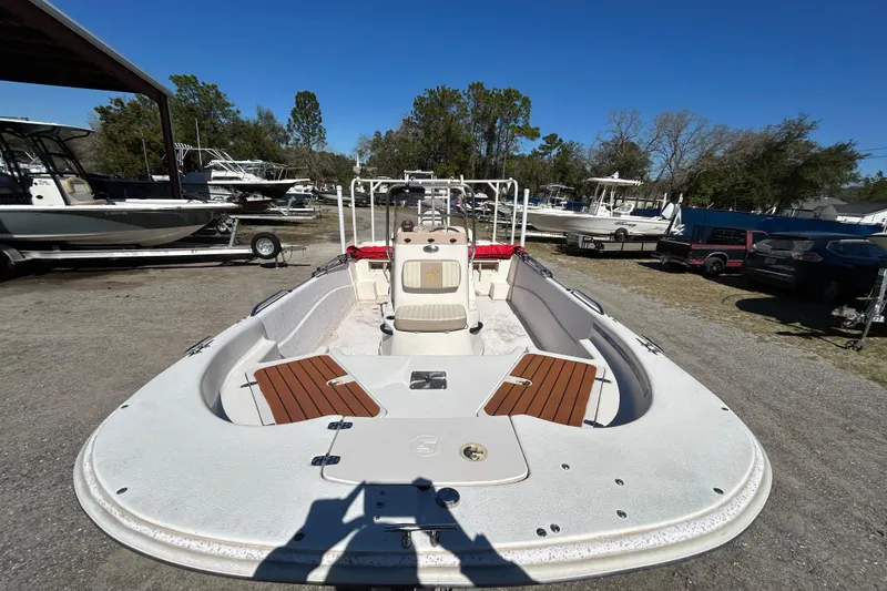 Slide: The Image of 2020 Carolina Skiff 178 DLV boat in outdoor storage area, surrounded by other boats. - 6