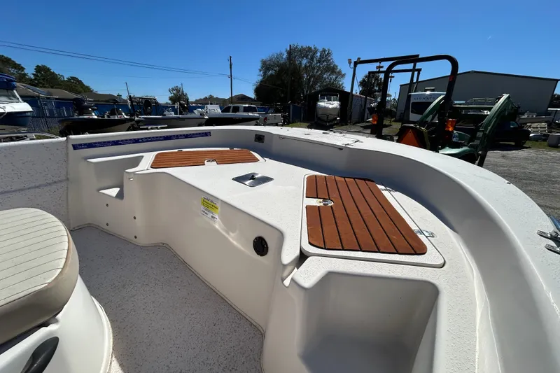 Slide: The Image of 2020 Carolina Skiff 178 DLV boat interior with wooden deck accents. - 7