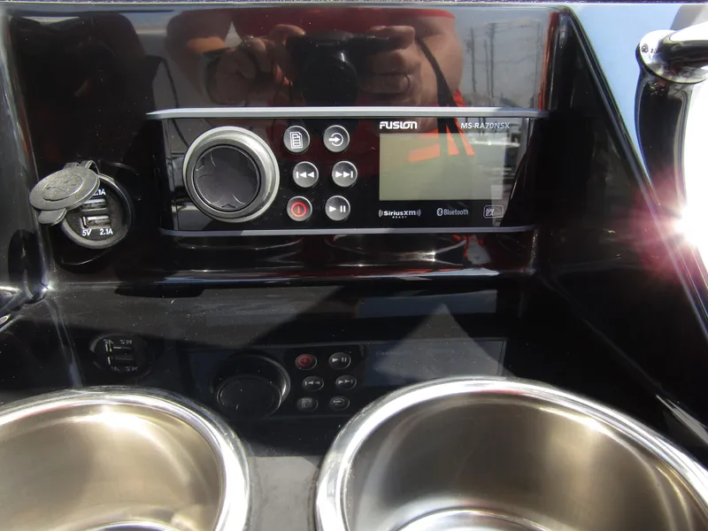 Slide: The Image of 2024 Wellcraft 202 Fisherman dashboard with Fusion audio system and cup holders. - 20