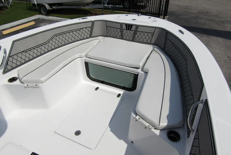 Slide: The Image of 2024 Wellcraft 202 Fisherman boat interior with cushioned seating and storage compartments. - 6