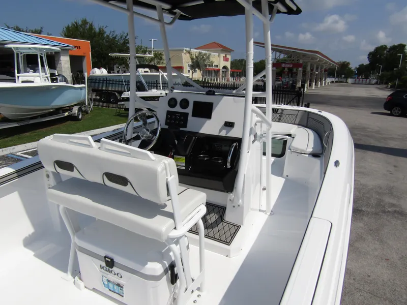 Slide: The Image of 2024 Wellcraft 202 Fisherman boat interior with helm and seating. - 27