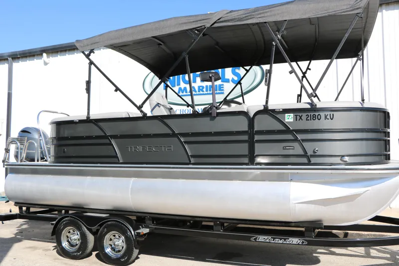 The Image of 2023 Trifecta 22 RFC pontoon boat with canopy on trailer, side view. - 1