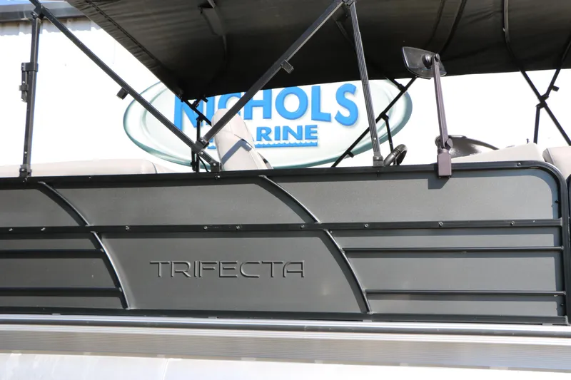 Slide: The Image of 2023 Trifecta 22 RFC pontoon boat at Nichols Marine dealership. - 11