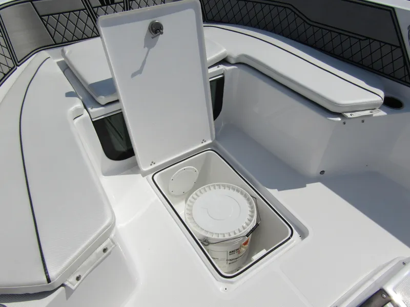 Slide: The Image of 2024 Wellcraft 202 Fisherman boat storage compartment with bucket. - 12