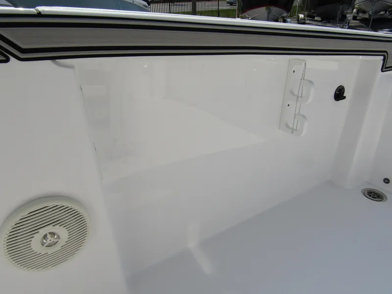 Slide: The Image of 2024 Wellcraft 202 Fisherman boat interior, featuring sleek white design and built-in speaker. - 21