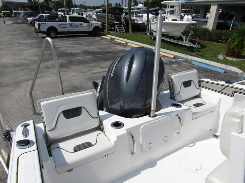Slide: The Image of 2024 Wellcraft 202 Fisherman boat with outboard motor in a dealership lot. - 23
