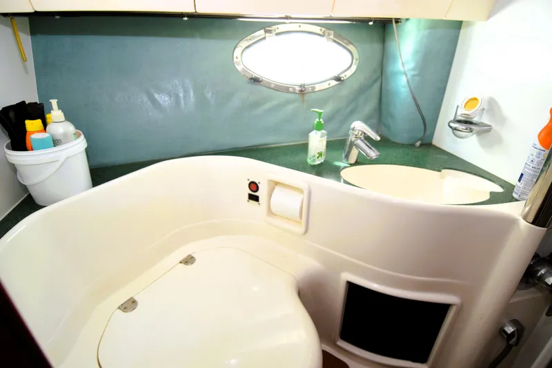 Slide: The Image of 1999 Fairline Targa 43 yacht bathroom with sink, porthole, and toiletries. - 11