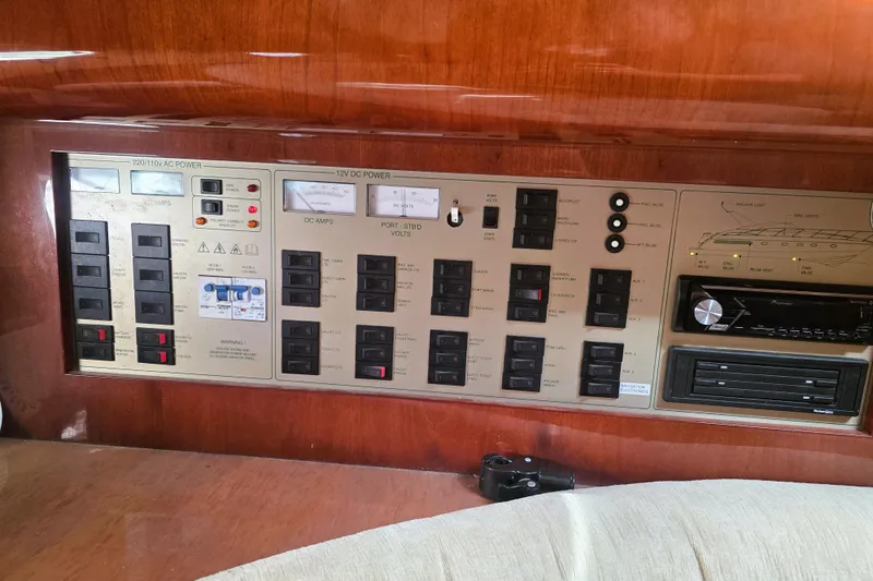 Slide: The Image of Control panel of a 1999 Fairline Targa 43 yacht, featuring various switches and gauges. - 18