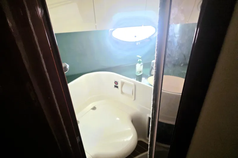 Slide: The Image of Bathroom interior of 1999 Fairline Targa 43 yacht with porthole and modern fixtures. - 22