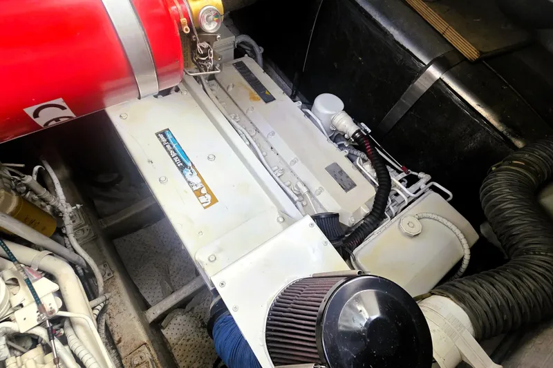 Slide: The Image of Engine compartment of a 1999 Fairline Targa 43 yacht, featuring mechanical components and hoses. - 30