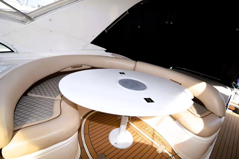Slide: The Image of Luxurious seating area on 1999 Fairline Targa 43 yacht with round table and cushioned seats. - 39