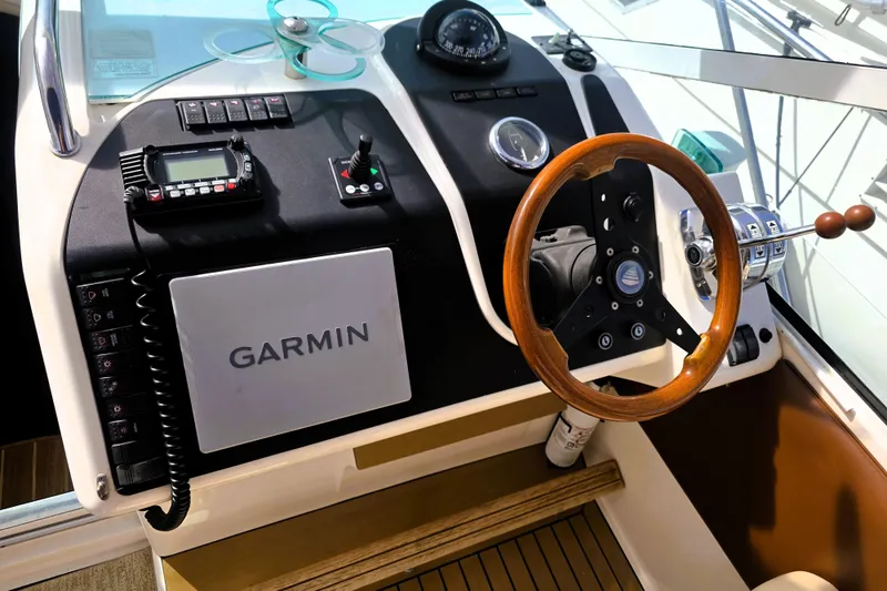 Slide: The Image of Cockpit of 1999 Fairline Targa 43 with Garmin navigation system and wooden steering wheel. - 4