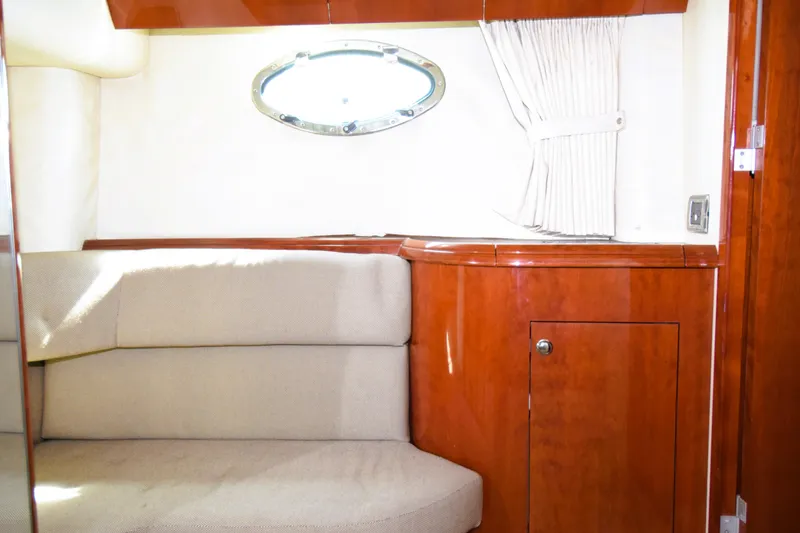 Slide: The Image of Interior of 1999 Fairline Targa 43 yacht with wood paneling and cushioned seating. - 9