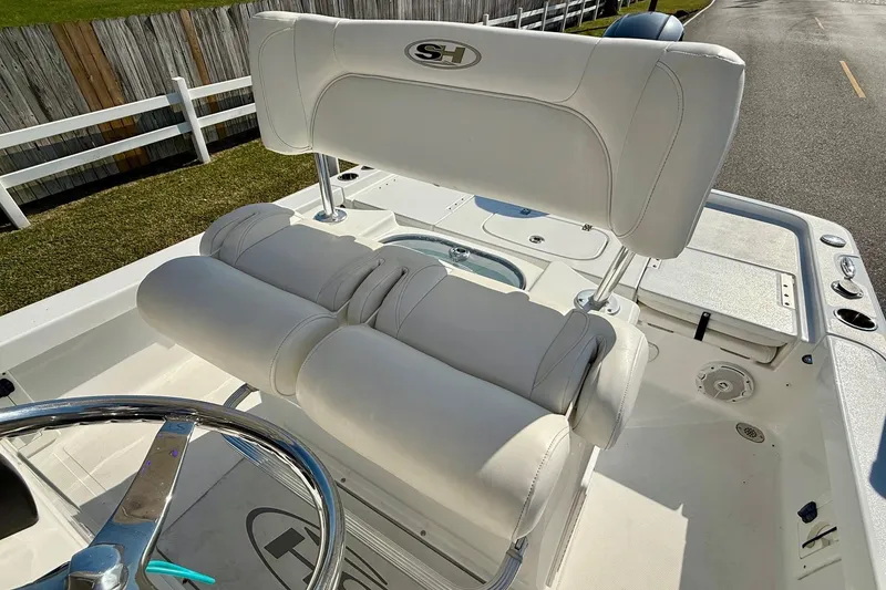 Slide: The Image of 2017 Sea Hunt BX 22 BR boat interior with white seating and steering wheel. - 10