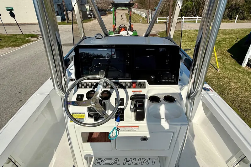 Slide: The Image of 2017 Sea Hunt BX 22 BR boat console with steering wheel and navigation controls. - 11