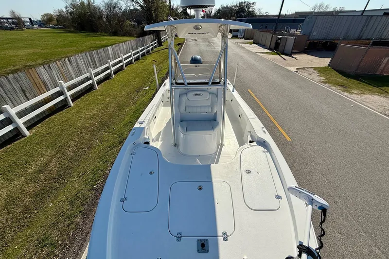 Slide: The Image of 2017 Sea Hunt BX 22 BR boat on a road, showcasing spacious deck and seating. - 17