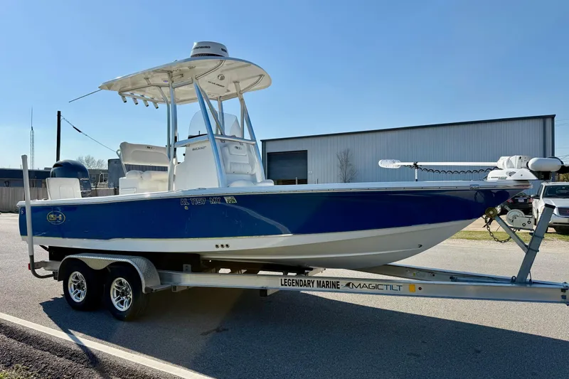 Slide: The Image of 2017 Sea Hunt BX 22 BR boat on trailer, blue hull, parked outdoors. - 5