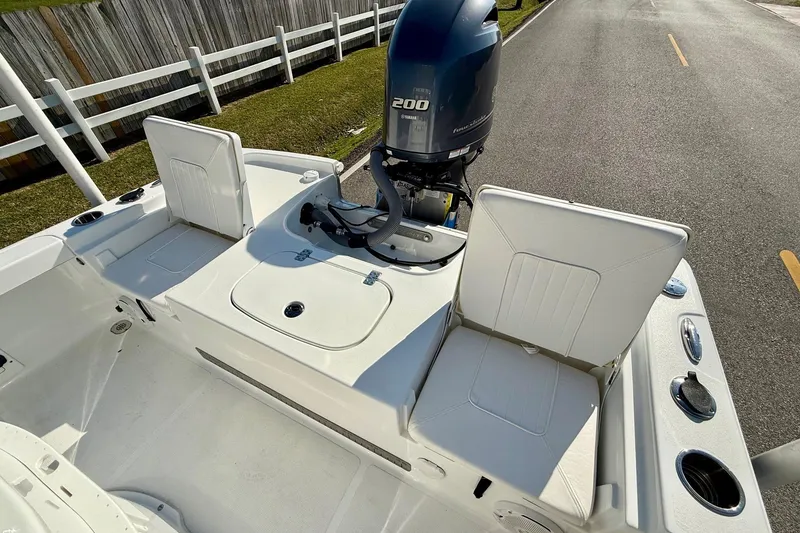Slide: The Image of 2017 Sea Hunt BX 22 BR boat with Yamaha 200 engine, featuring white seating and storage. - 7