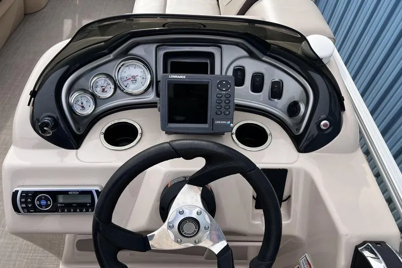Slide: The Image of 2026 Sun Tracker Party Barge 20 DLX dashboard with steering wheel and control panel. - 10