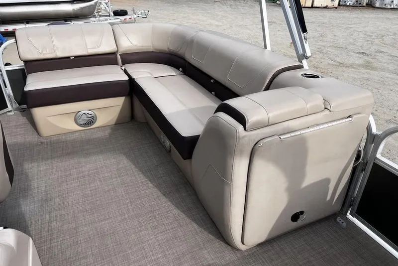 Slide: The Image of 2026 Sun Tracker Party Barge 20 DLX interior seating with beige and brown upholstery. - 15