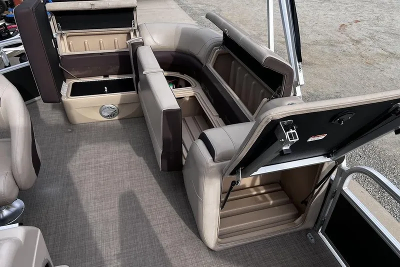 Slide: The Image of 2026 Sun Tracker Party Barge 20 DLX interior with open storage compartments. - 17