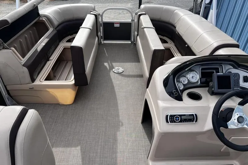 Slide: The Image of 2026 Sun Tracker Party Barge 20 DLX interior with seating and control panel. - 18