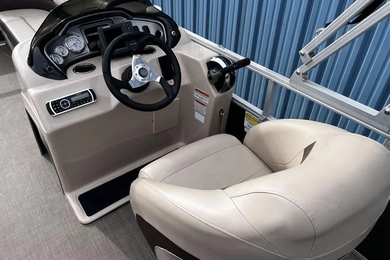 Slide: The Image of 2026 Sun Tracker Party Barge 20 DLX helm with steering wheel and control panel. - 8