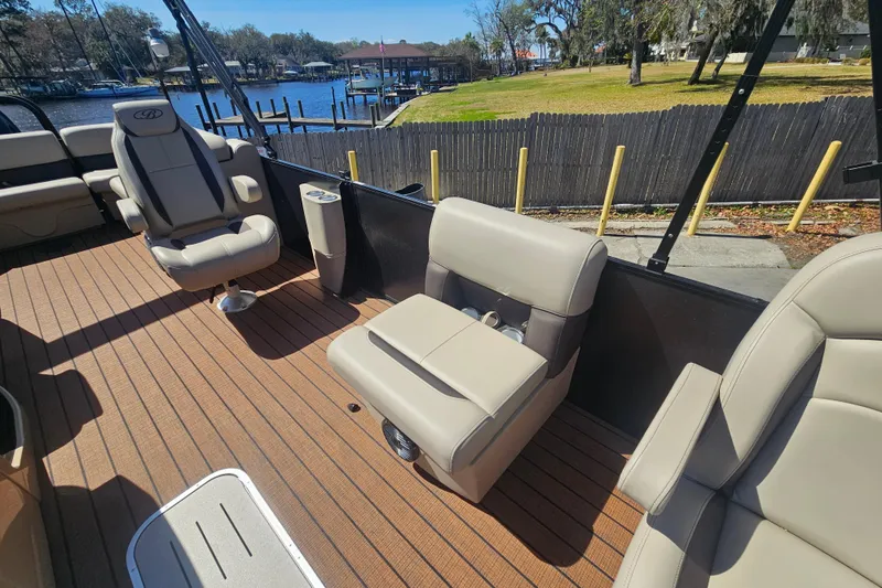 Slide: The Image of 2026 Bentley Pontoons Fish 243 Center Walk Through interior with comfortable seating and scenic lake view. - 16