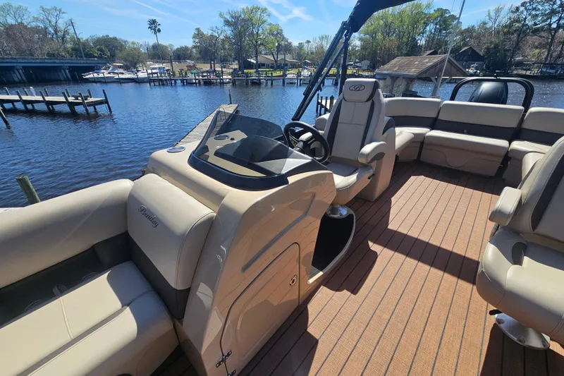 Slide: The Image of 2026 Bentley Pontoons Fish 243 Center Walk Through on a serene waterfront dock. - 18