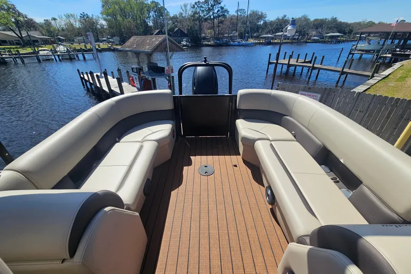 Slide: The Image of 2026 Bentley Pontoons Fish 243 Center Walk Through on a scenic waterfront dock. - 25