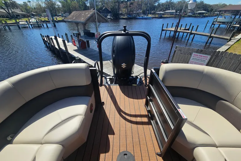 Slide: The Image of 2026 Bentley Pontoons Fish 243 Center Walk Through on a scenic dockside view. - 26