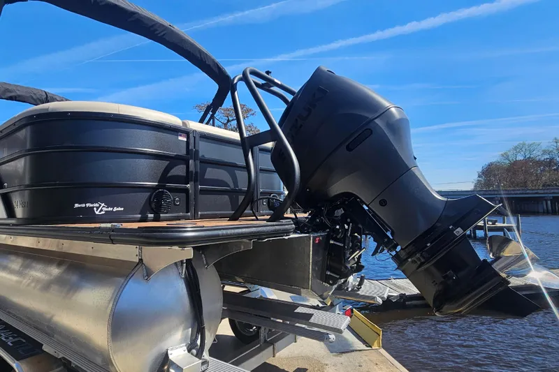 Slide: The Image of 2026 Bentley Pontoons Fish 243 Center Walk Through with Suzuki outboard motor at dock. - 3