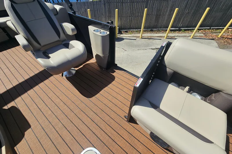 Slide: The Image of 2026 Bentley Pontoons Fish 243 Center Walk Through interior with beige seating and wood-style flooring. - 35