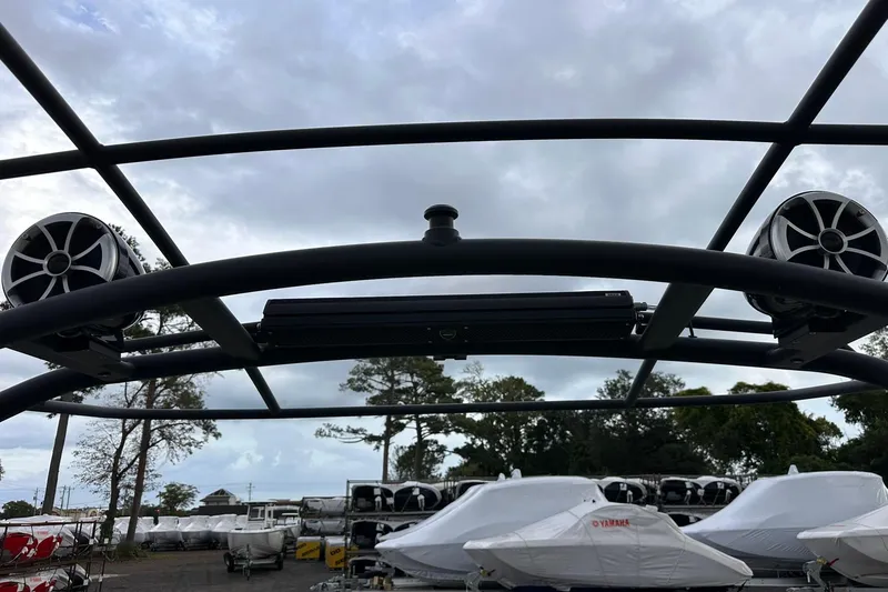 Slide: The Image of 2022 Yamaha Boats 255XD wakeboard tower with speakers, under cloudy sky. - 14